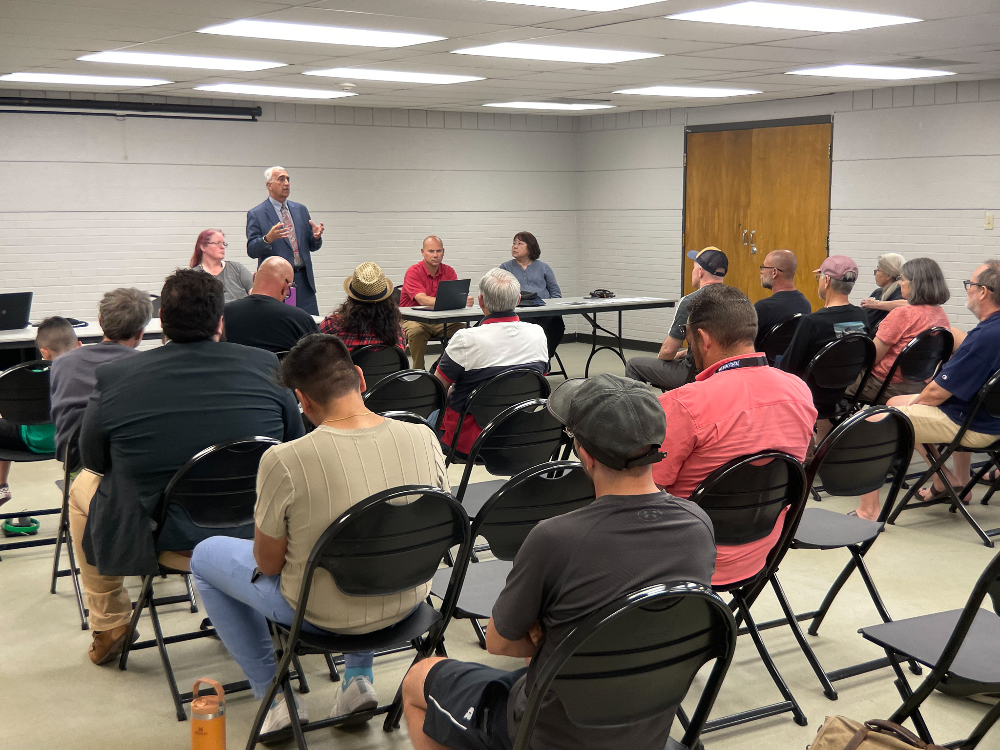 A person addressing a group of people.