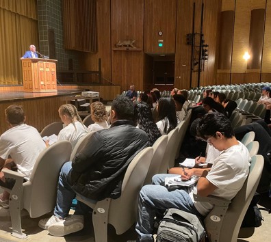 A group of people sitting in chairs.