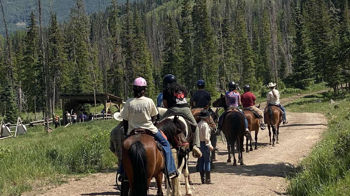 A group of people riding horses.