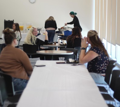 A group of people sitting at tables.