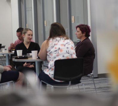 A group of people sitting around a table.