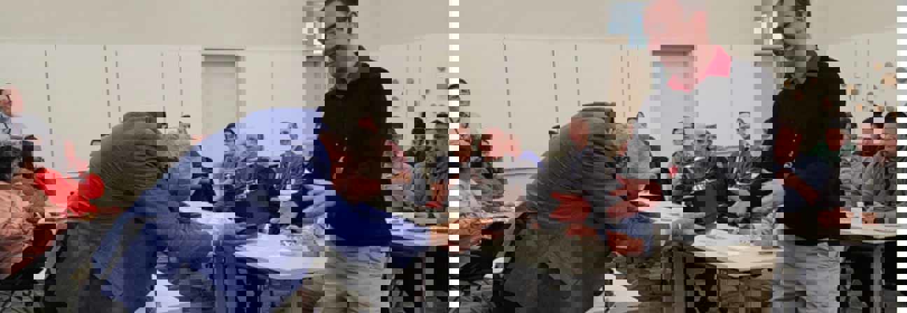 A man shaking hands with a man in a suit.