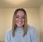 A woman smiling for the camera.