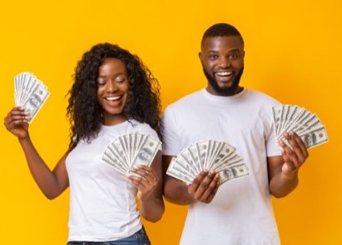A man and woman holding a fan.