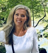 A woman smiling for the camera.