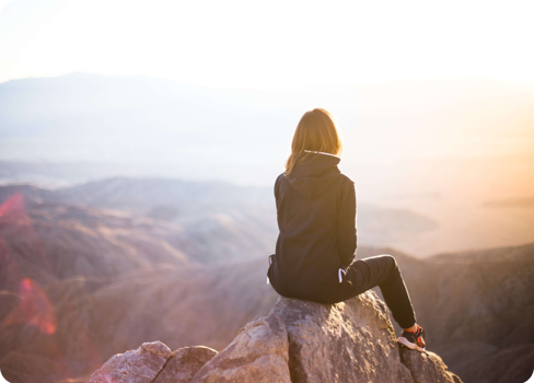 A man sitting on a rock.