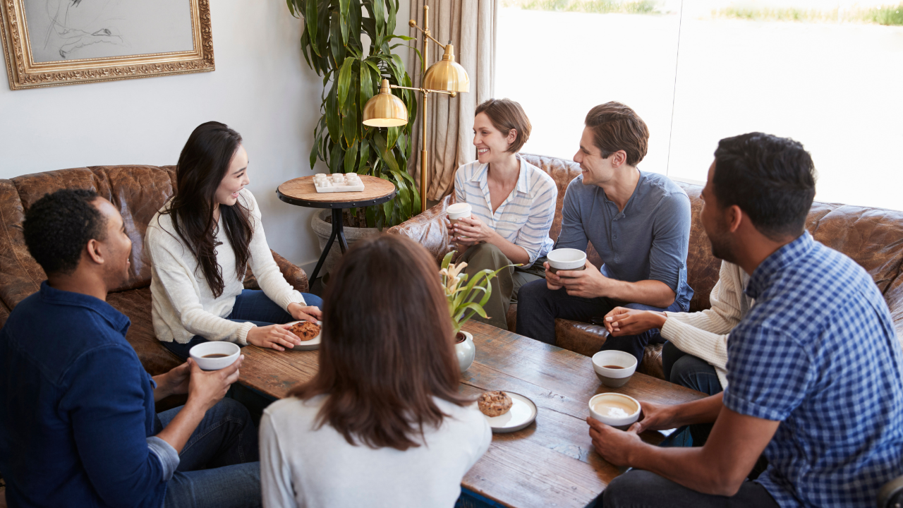 A group of people sitting around a table.