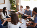 A group of people sitting around a table.