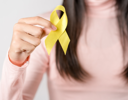 A woman holding a yellow banana.