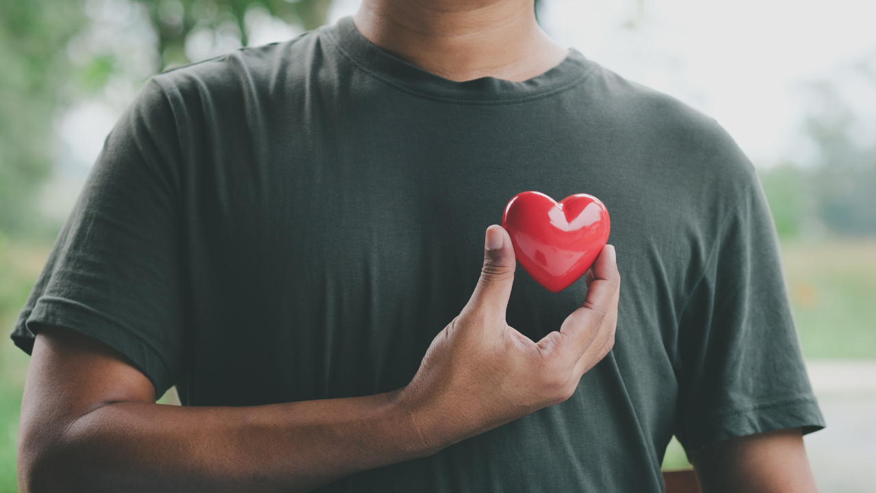 A person holding a red heart.