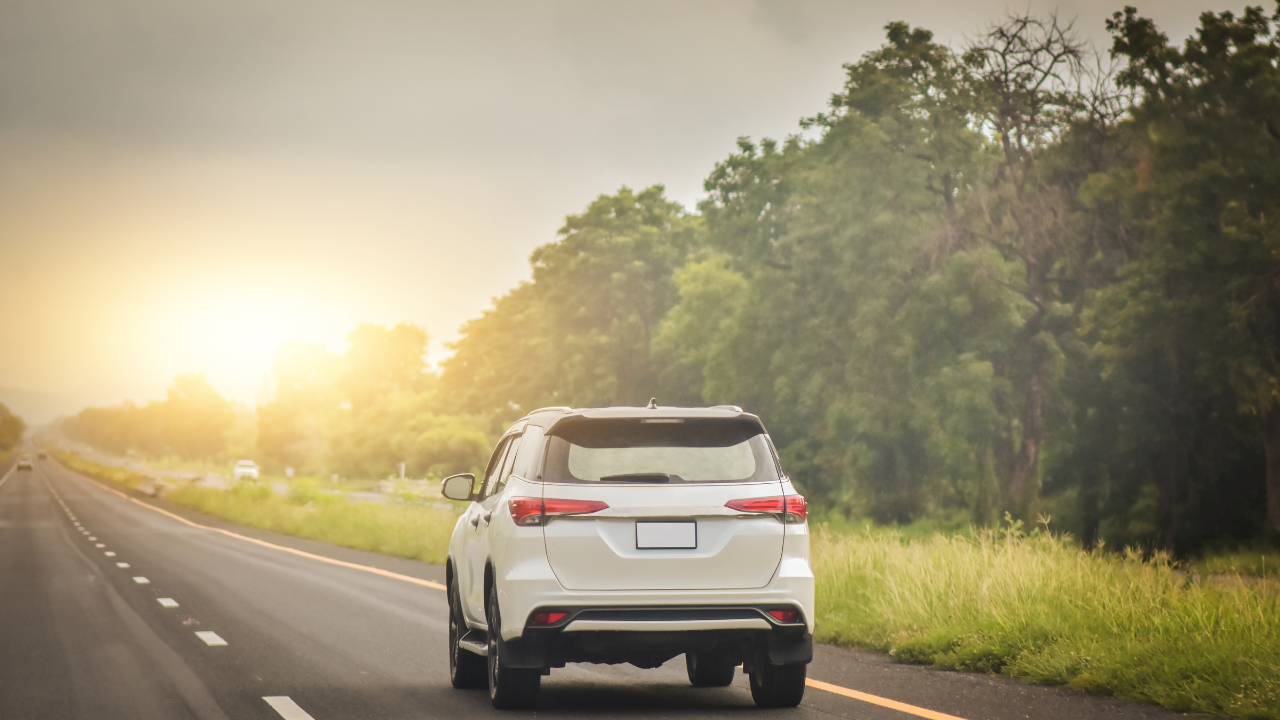 A white car on a road.