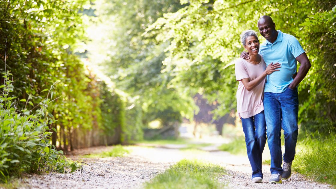 Carla Harris et al. walking on a path in the woods.
