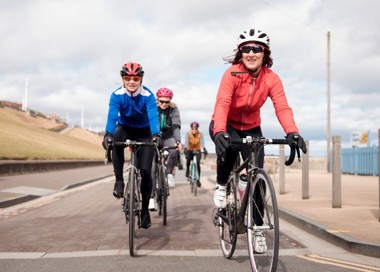 A group of people riding bikes.