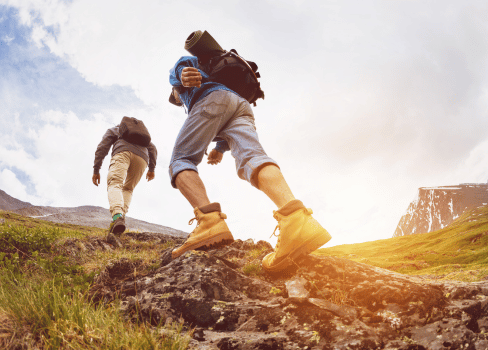 A few people climbing a rock.