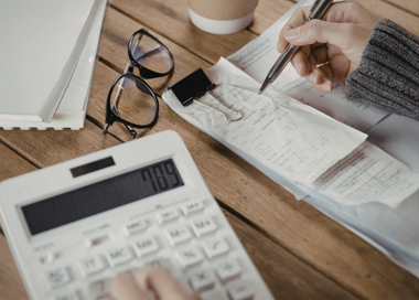 A person writing on a piece of paper.