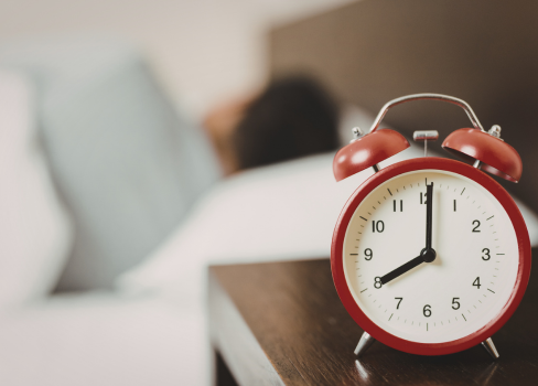 A clock with a heart shaped bell.
