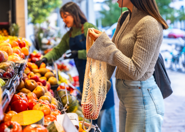 A woman looking at a bag.