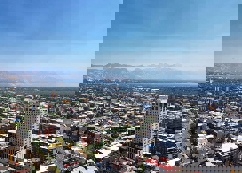 A city with a mountain in the background.