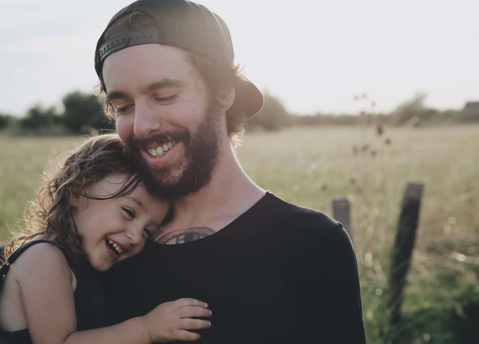 A man and woman taking a selfie in a field.