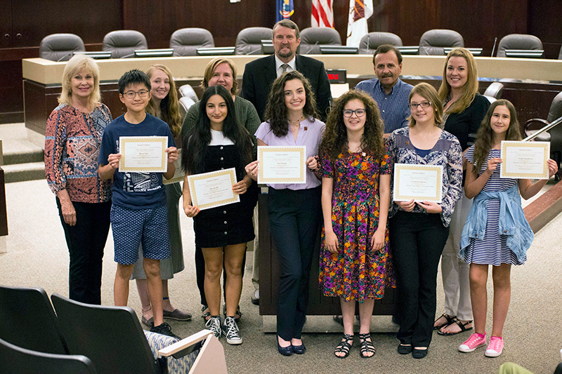 A group of people holding certificates.