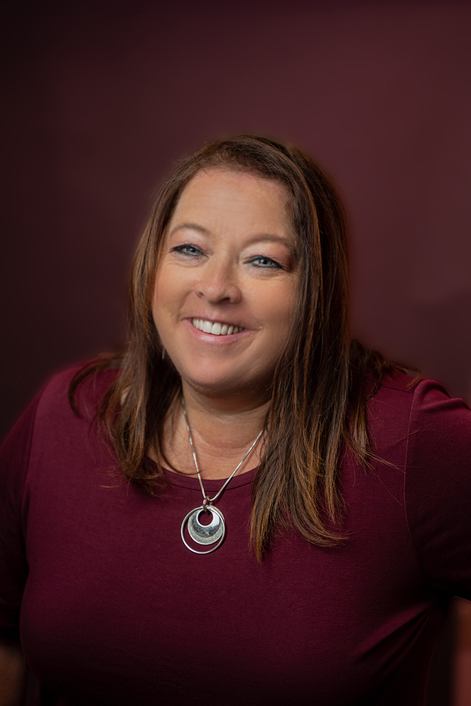 A woman smiling for the camera.