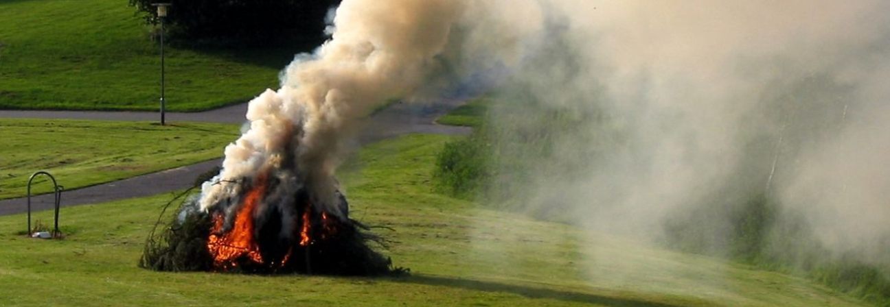 A large fire on a field.