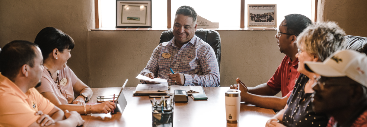 A group of people sitting around a table.