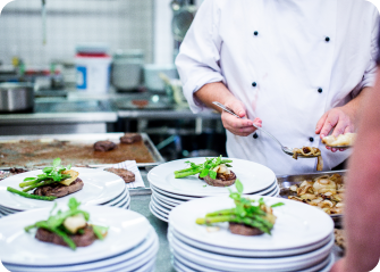 A chef preparing food in a kitchen.