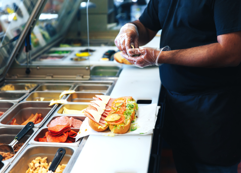 A person preparing food in a restaurant.