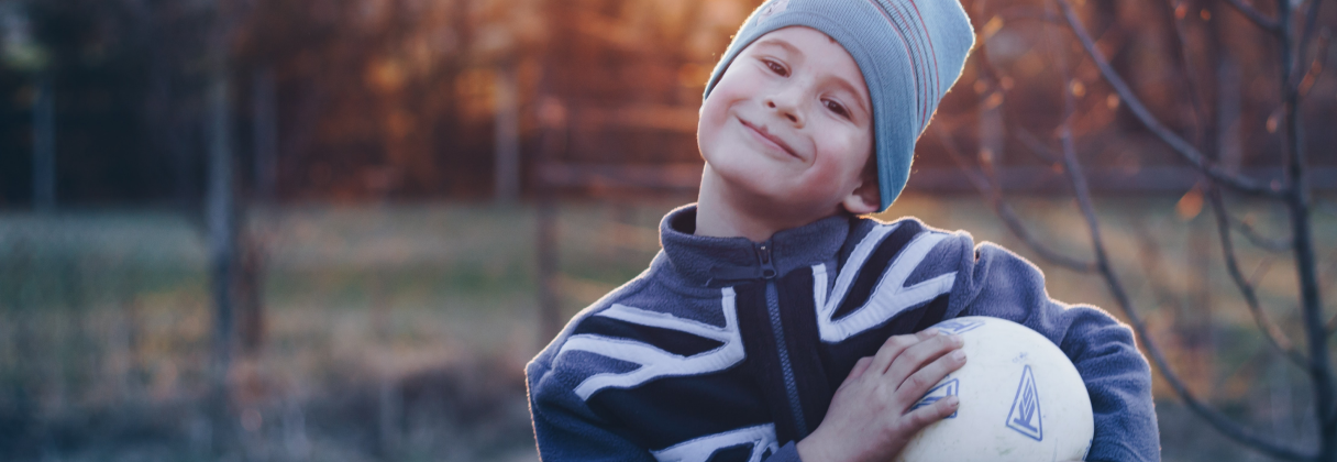 A boy holding a ball.