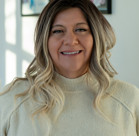 A woman smiling for the camera.