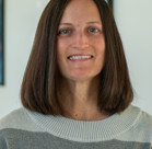 A woman smiling for the camera.