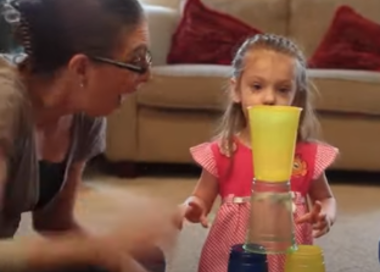 A person and a girl drinking juice.