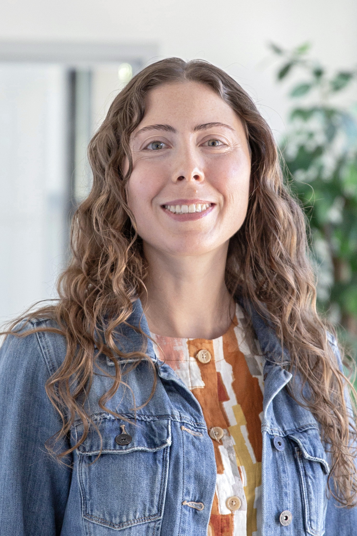A woman with long hair smiling.