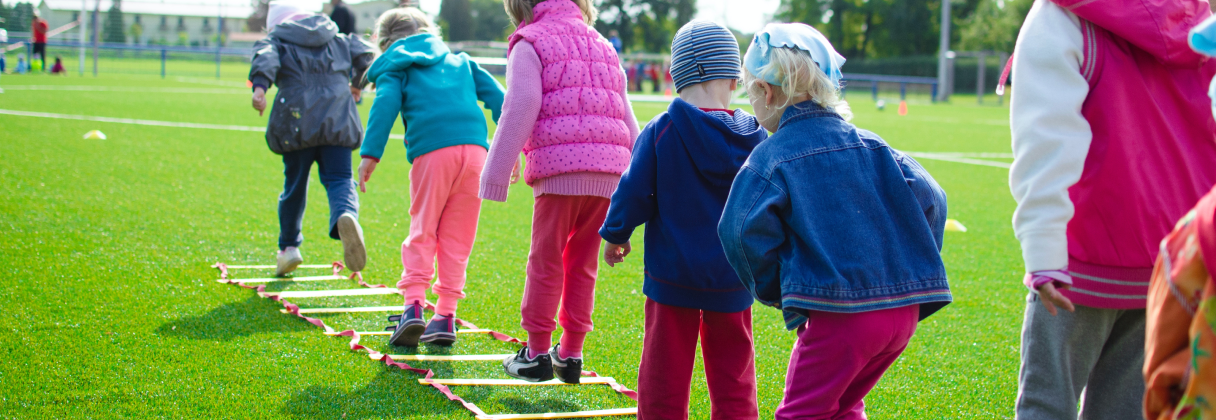 A group of people walking on a field.