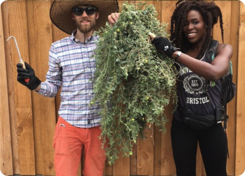 A man and woman holding a pineapple.