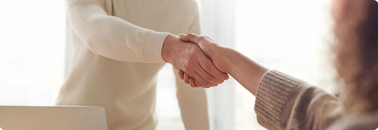 A close-up of a man shaking hands with a woman.