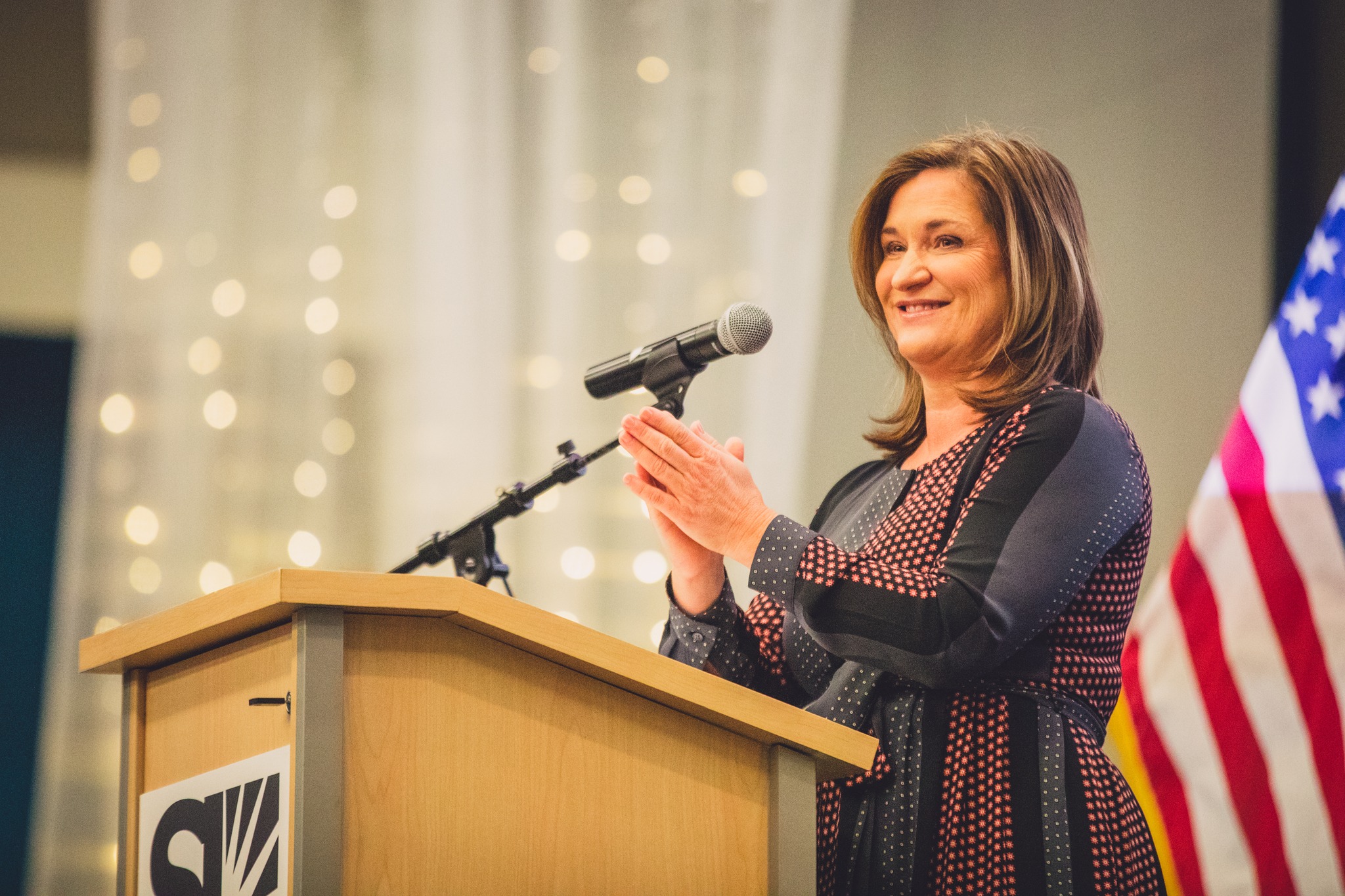 Jenny Wilson speaking into a microphone.