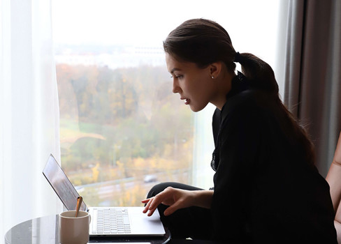 A person sitting at a table with a laptop.