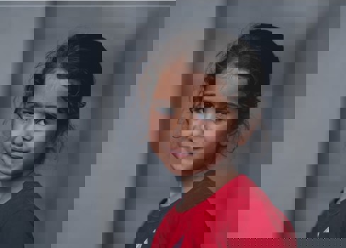 A young girl smiling.