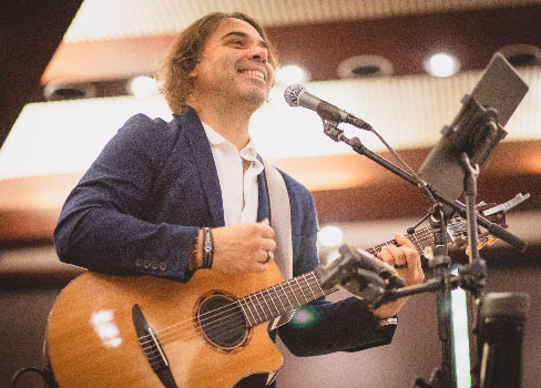 A man playing a guitar.