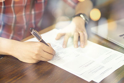 A person writing on a piece of paper.