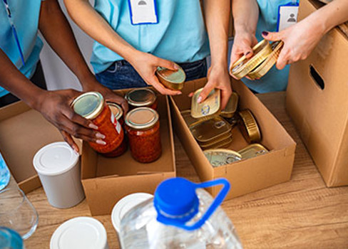 A group of people holding containers of food.