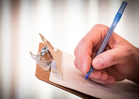 A hand holding a pen.