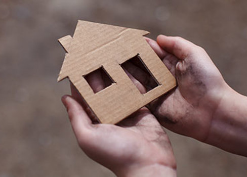 A hand holding a small wooden box.
