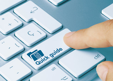 A hand holding a white keyboard.
