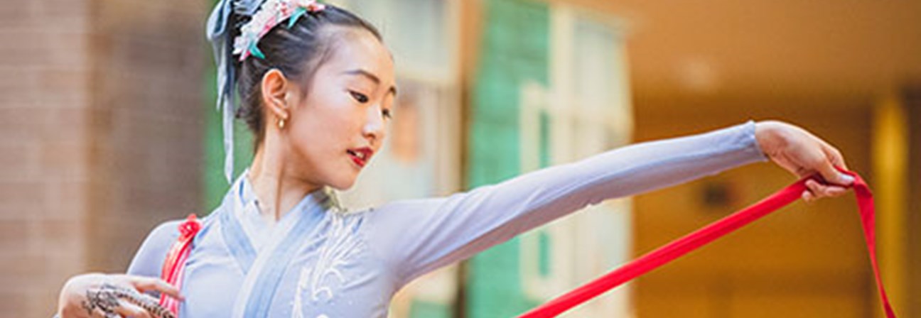 A person holding a red and white pole.