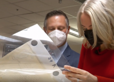 A man and a woman looking at a model of a space ship.
