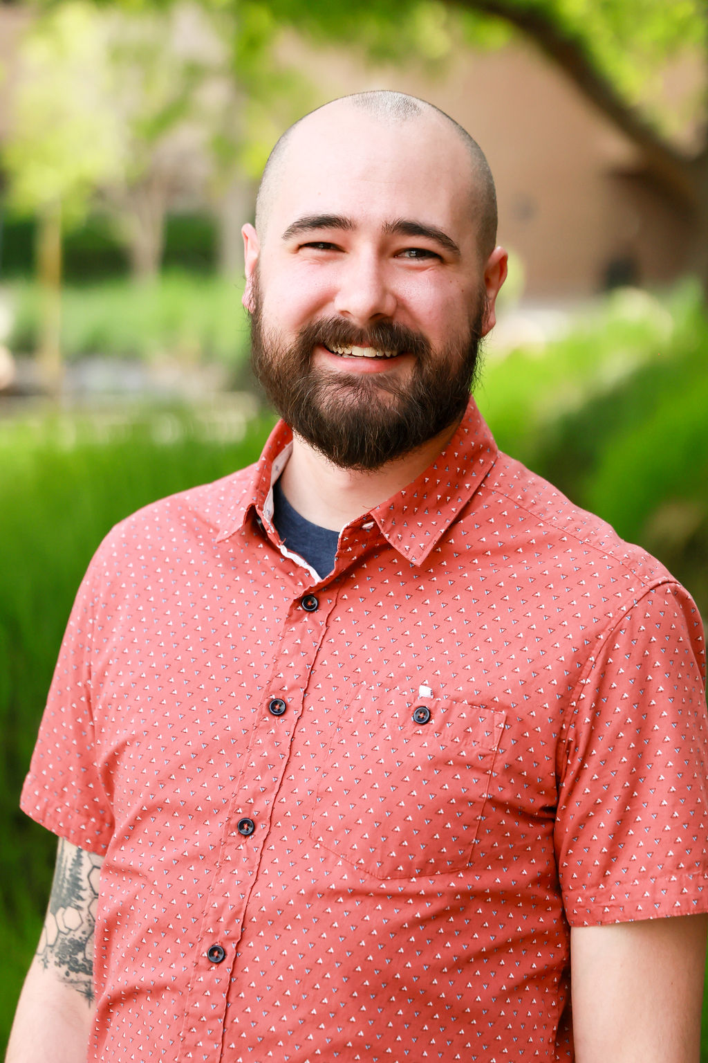 A man with a beard and tattoos.