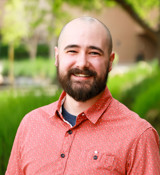 A man with a beard and tattoos.